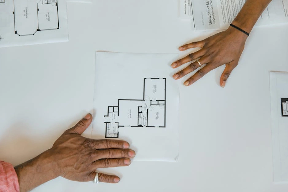 A modern, minimalist Scandinavian office workspace with a team collaborating.